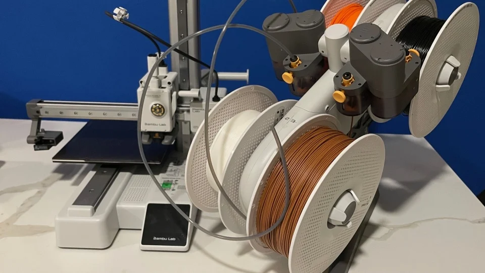 Multi-filament setup on a Bambu Lab 3D printer with various spools loaded.